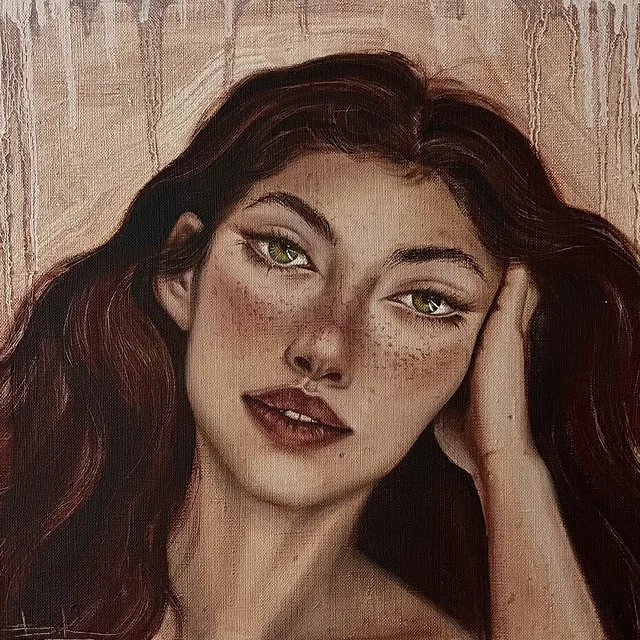 Woman with dark auburn hair resting her cheek on her hand against a warm pale ground
