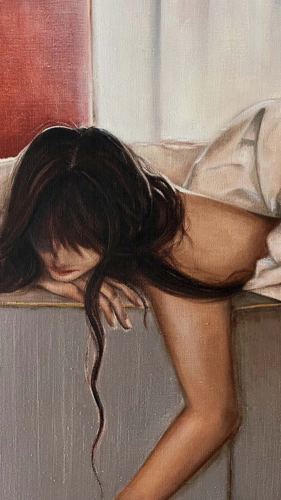 Detail: her face hidden by dark hair, resting on her arm