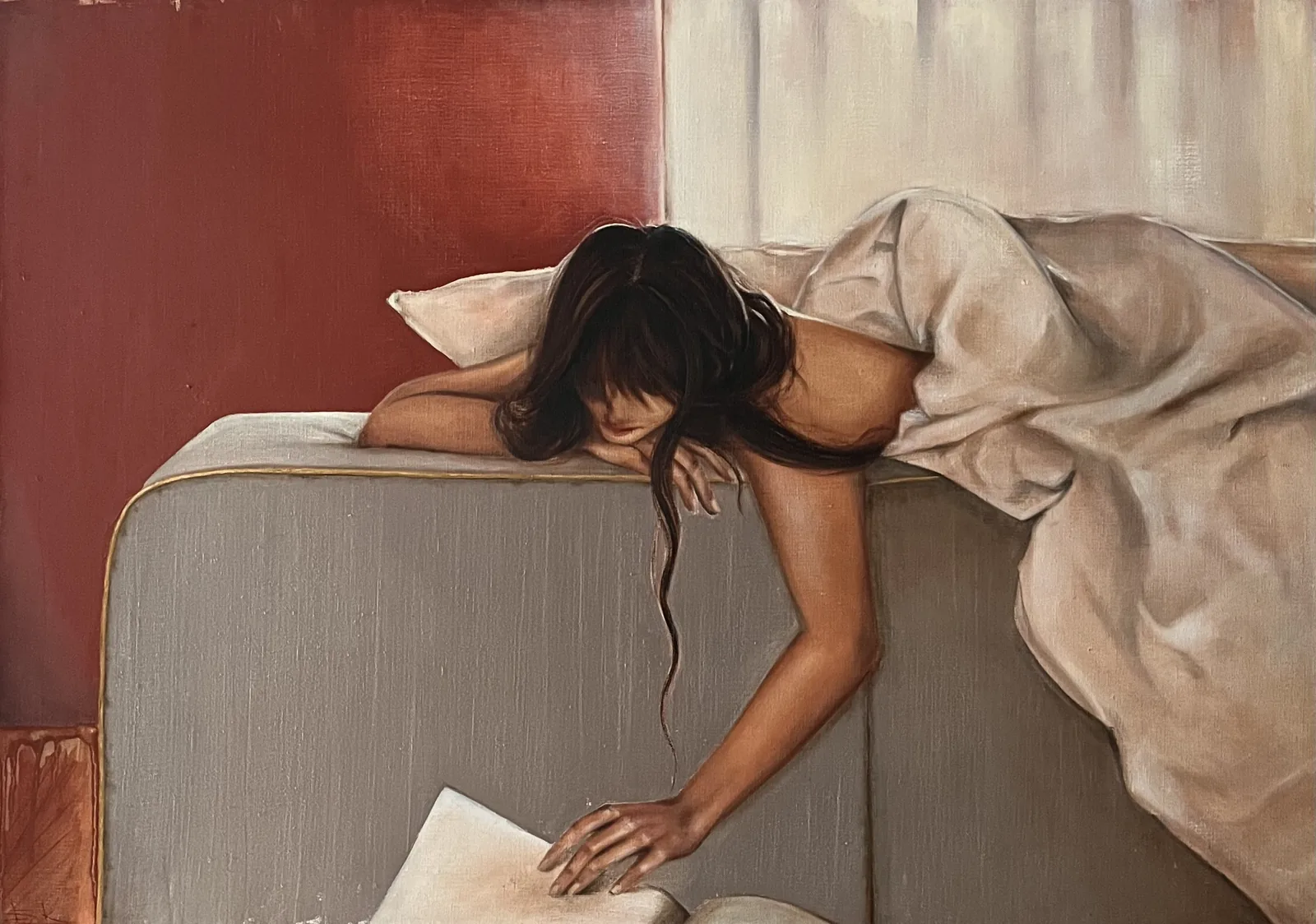 Woman lying across a sofa, a sheet gathered around her, a book slipping from her hand