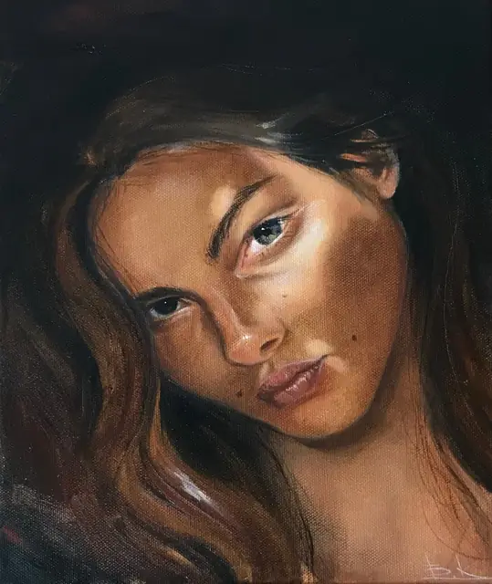 Dark-haired woman looking straight out of a warm shadowed background