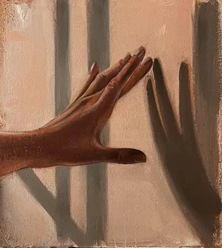 A hand pressed against a sunlit wall, its shadow falling beside it